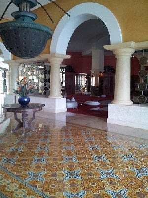 The above commercial installation of Cuban cement tile uses a classic rug design in rich, warm colors.