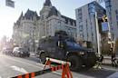 A RCMP vehicle passes the Fairmont Chateau Laurier as it leaves a secure area downtown following shootings in Ottawa
