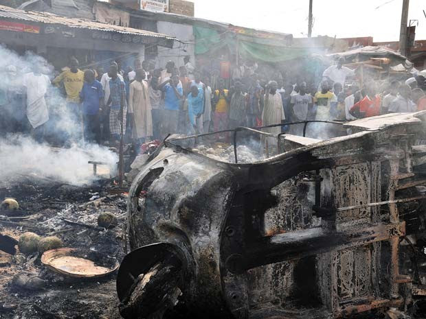 Veículo pega fogo depois de explosão de bomba nesta terça (1º) em mercado na cidade de Maiduguri, na Nigéria (Foto: AFP PHOTO/STRINGER)