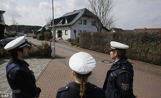 Under guard: Police keep the media away from the house where pilot Andreas Lubitz lived in Montabaur, Germany, after it was revealed he was responsible for the death of all 150 people on board the Airbus A320