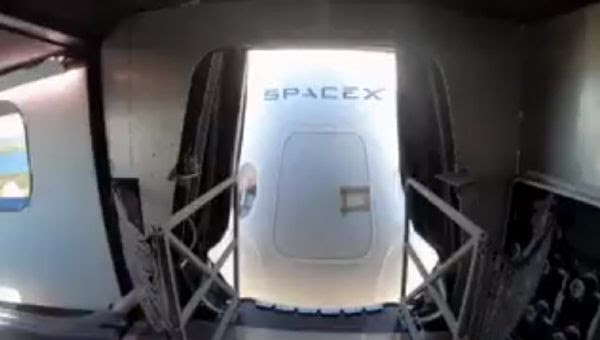 SpaceX's Crew Dragon capsule as seen from inside the Crew Access Arm at Kennedy Space Center's Launch Complex 39A.