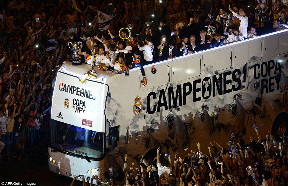 Man of the moment: Gareth Bale (circled) joins his Real Madrid team-mates as they celebrate their triumph over Barcelona on their return to the capital