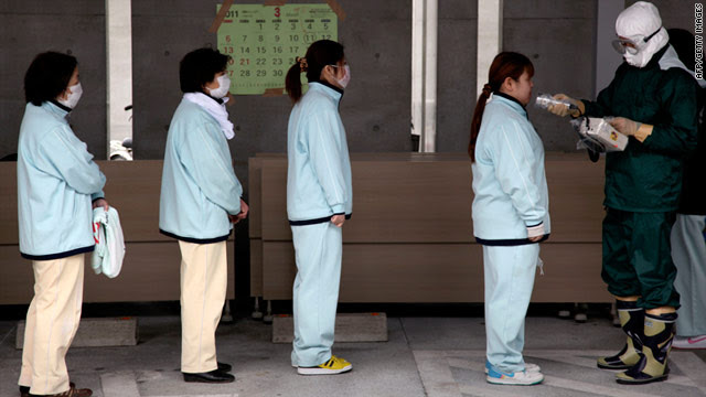 People line up for radiation screening at Koryama in Fukushima prefecture on Monday.