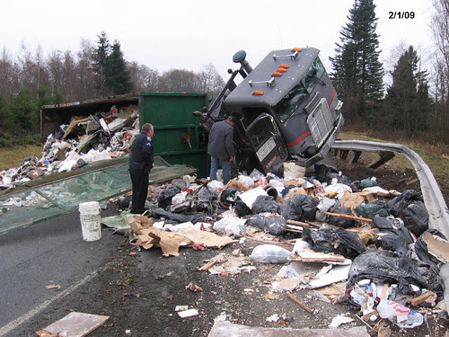 Garbage truck spills its load