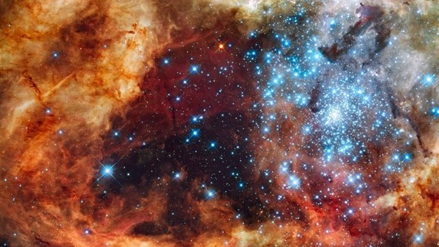 Blue stars wreathed by warm, glowing clouds 