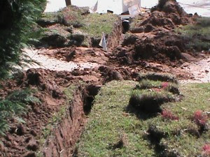French Drain going under sidewalk and draining through curb