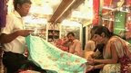 people looking at saris
