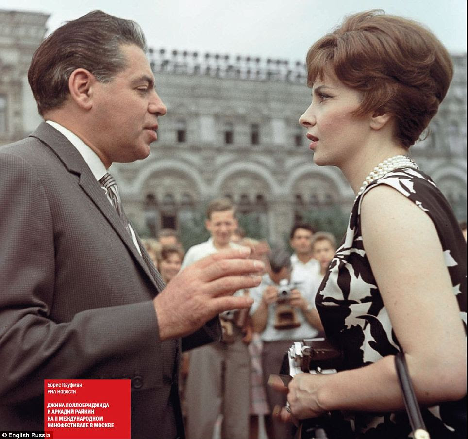 Discussing the five-year plans? A smartly dressed man and woman chat as a crowd looks on in this picture