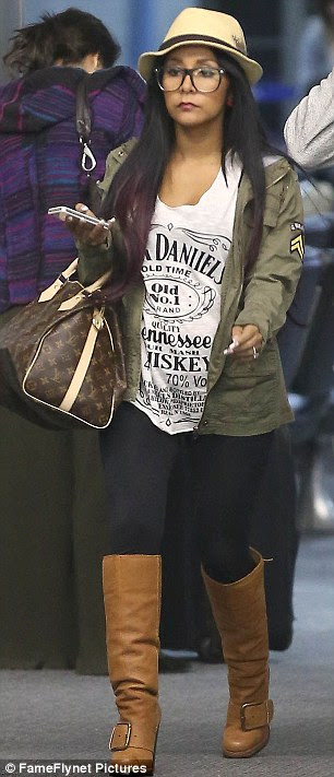 Dressed-down style: Snooki displayed her slim figure in leggings and a Jack Daniels T-shirt as she touched down at Los Angeles' LAX airport