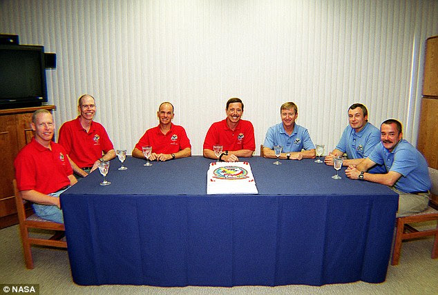 Another equally odd moment is when the crew is presented with a fully iced cake at the prelaunch breakfast, shown here. But it's not for eating. The cake is decorated with the crew's mission patch and simply sits there, for reasons that are somewhat unknown