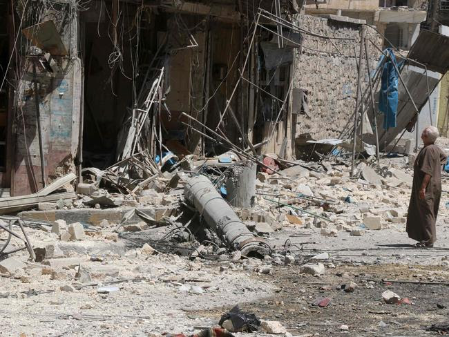 A resident of the Tariq al-Bab neighbourhood of Aleppo, inspects the damage caused by air raids. Picture: AFP/THAER MOHAMMED