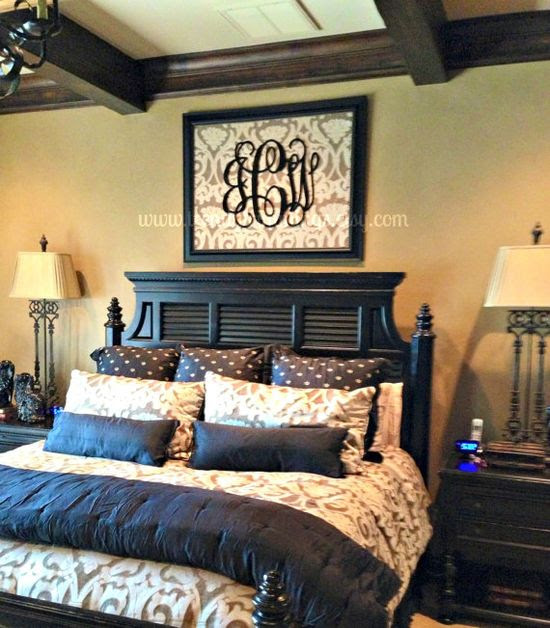 Monogram frame above bed
