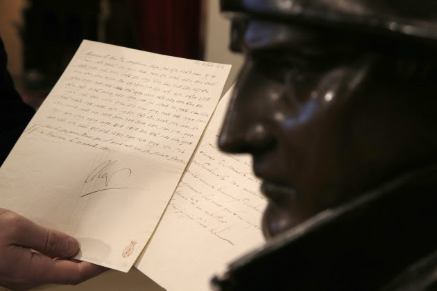 In this photo taken Wednesday, Nov. 28, 2012, a letter dictated and signed by Napoleon in secret code that declares his intentions "to blow up the Kremlin" during his ill-fated Russian campaign is displayed for the media in Fontainebleau, outside Paris. The rare letter, written in unusually emotive language, sees Napoleon complain of harsh conditions and the shortcomings of his grand army. The letter goes on auction Sunday, Dec. 2, 2012. (AP Photo/Christophe Ena)