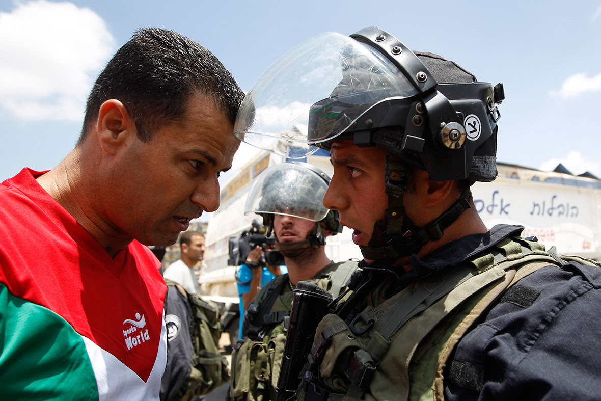 A Palestinian protester argues with an Israeli border policeman during a demonstration in solidarity with hunger-striking Palestinian prisoners, outside Israel's Ofer military prison near Ramallah.