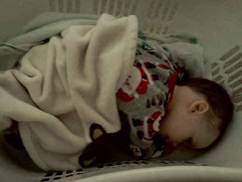 Pretending to sleep in the laundry basket by lilbitfromks