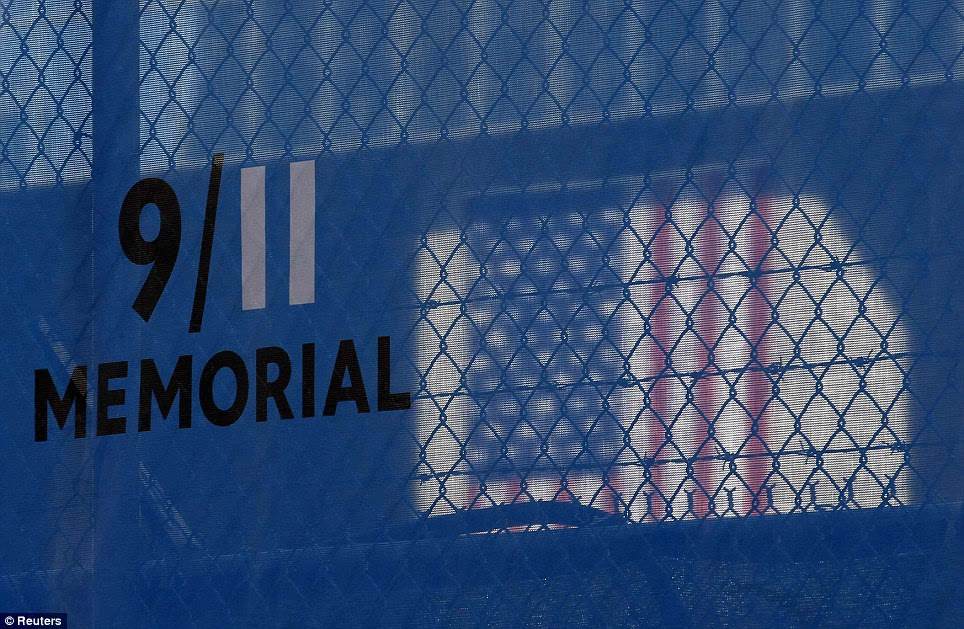 Patriotic: A U.S. flag is seen through the mesh surrounding the perimeter at the World Trade Center construction site in New York on Friday evening
