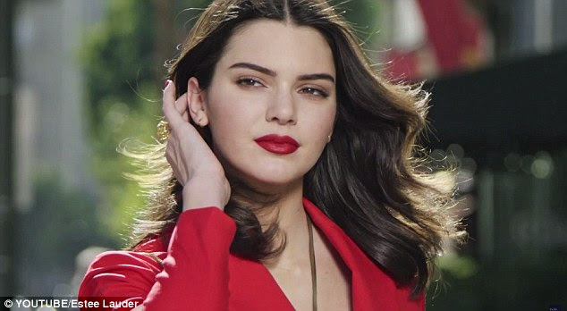 Lady in red: A behind-the-scenes video of the shoot shows the 19-year-old wearing bright rouge lipstick that matches her suit