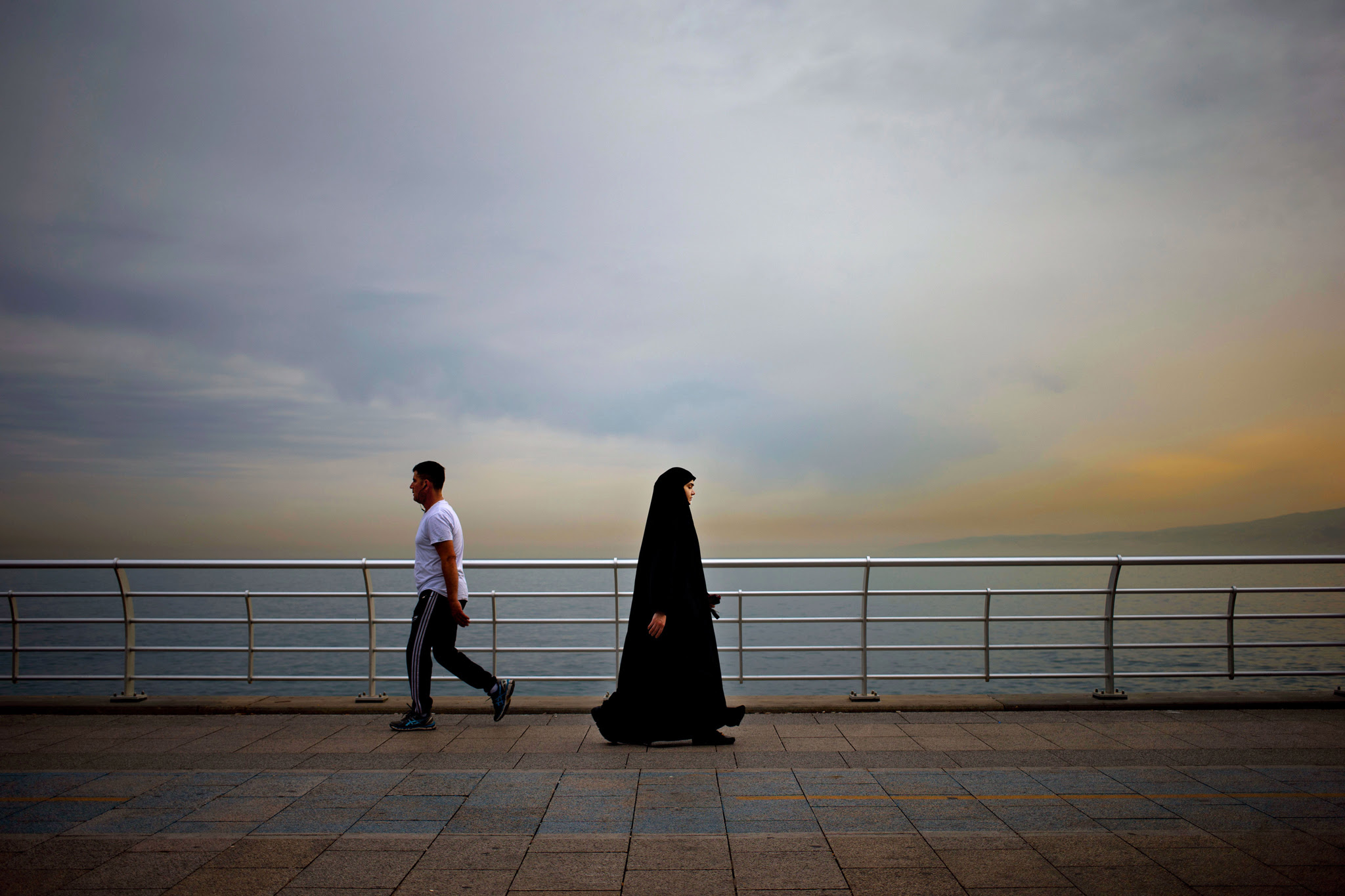 Citizens walk on the Corniche, or waterfront promenade along the Beirut coastline, Lebanon, Thursday, May 26, 2016. (AP Photo/Hassan Ammar)