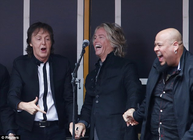 The band can't control their laughter as they laugh at something very funny