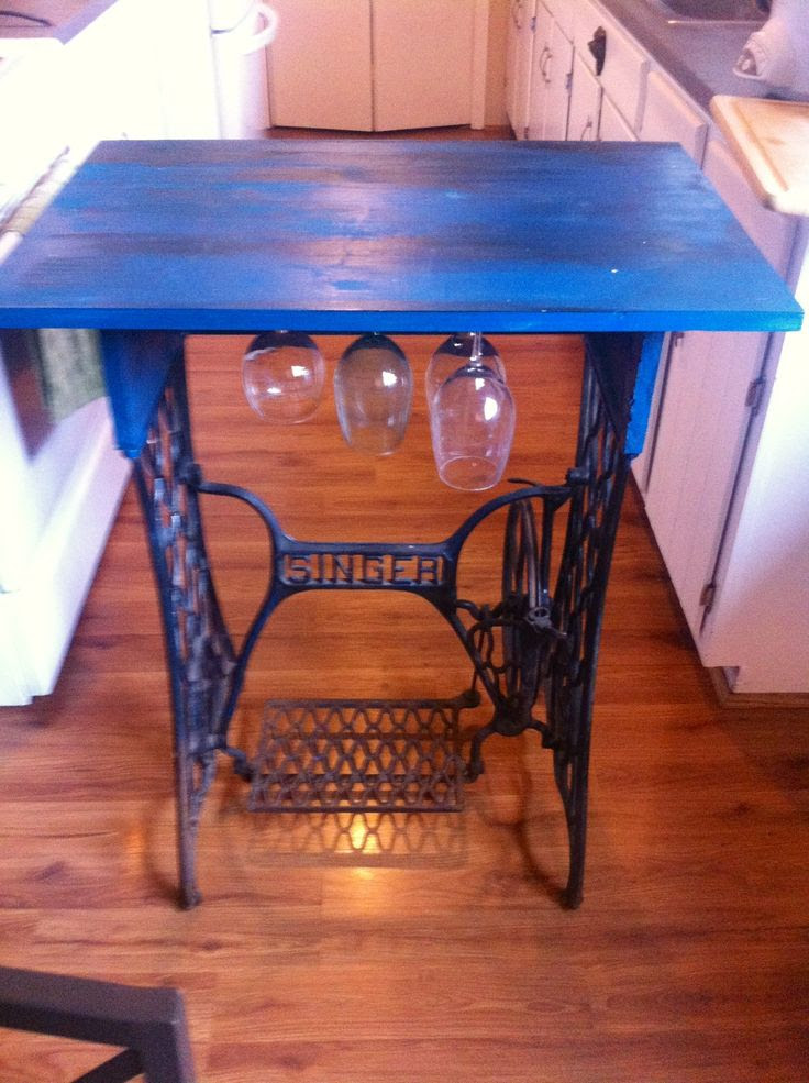 Small table with wine glass storage from old singer sewing machine legs :)
