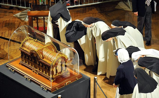 Visiting nuns venerate the relics of St Therese of Lisieux inside Westminster Cathedral