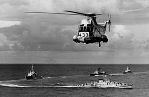 A Sea King helicopter hovers over ships on anti-submarine patrol, June 17, 1976. 