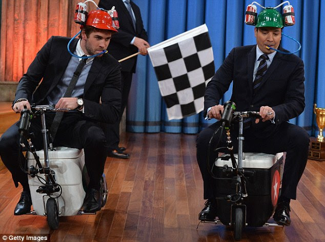 Tough competition: Jimmy challenged Liam to a cart race while wearing beer helmets