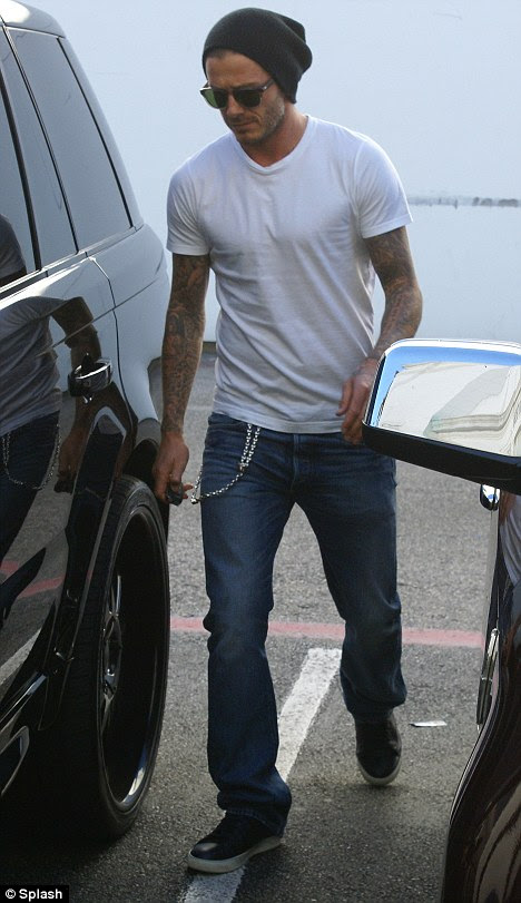 Handsome: David went casual for the outing, but still looked as 
handsome as ever in a white T-shirt and pair of jeans with his wallet 
chain at the pocket