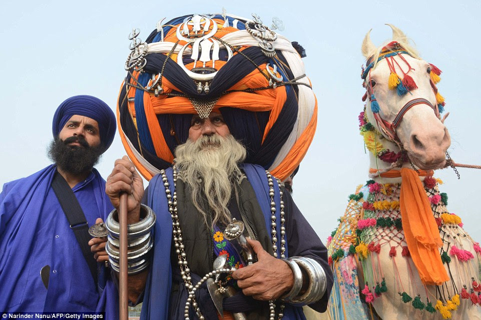 An Indian Sikh 'Nihang' - traditional Sikh warrior - called Baba 'Avtar' Singh wears an oversized 2,132-foot-long turban during a Fateh Divas celebration in Amritsar on October 31, 2016