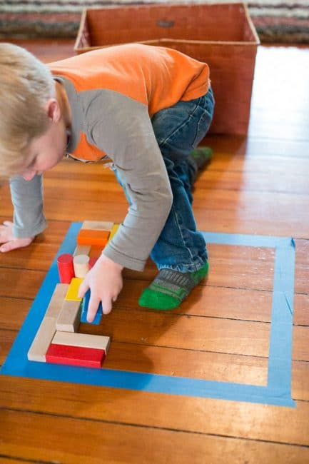 Make a puzzle on the floor with a simple shape and fill it in with blocks.