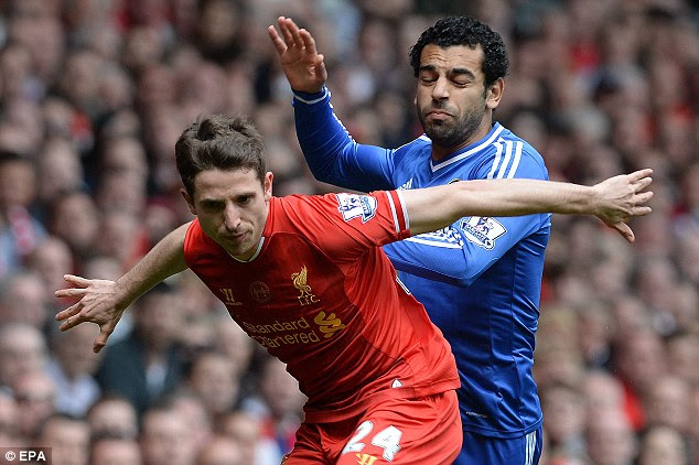 Holding him off: Joe Allen protects possession when Salah tries to nip in an launch an attack