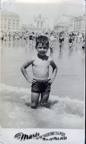 By the sea - One  little boy, dark suit in surf