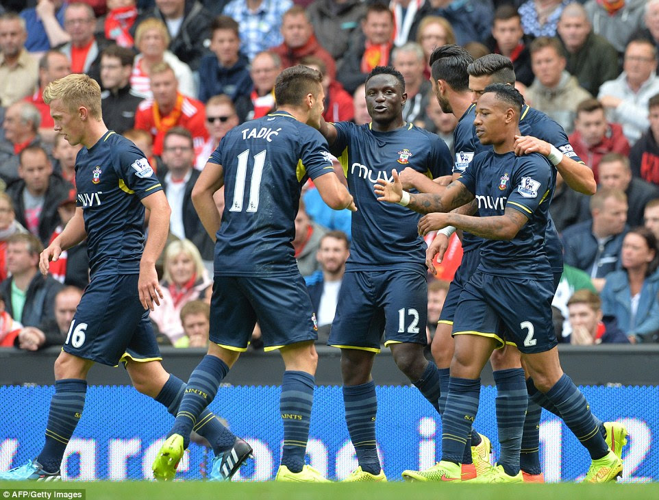 Together: Southampton's players mass together to congratulate Clyne (right) following his equaliser