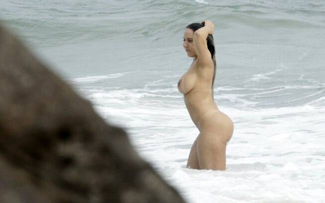 Completamente nua, Mulher Melão, tomou banho de mar na praia de Abricó. Foto: Gabriel Rangel / AgNews