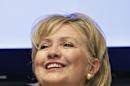 FILE - This June 2, 2014, file photo shows Hillary Clinton smiling during a meeting with community leaders after touring Intertech Plastics in Denver. The former Secretary of State said in an interview with ABC News Sunday, June 8, 2014, that she will decide whether to run for president again "when it feels right for me to decide." For now she says she is focused on promoting her new book and helping fellow Democrats in the mid-term elections in the fall. Clinton says potential Democratic rivals are free to choose what they would like to do. (AP Photo/Brennan Linsley, File)