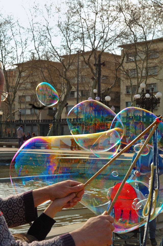 Man and child making soap bubbles in Barcelona [enlarge]