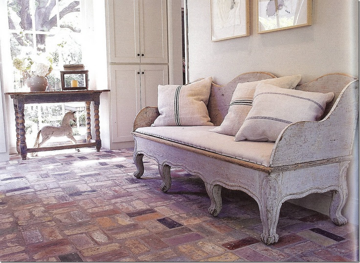 antique swedish sofa with grainsack pillows - love the brick floor