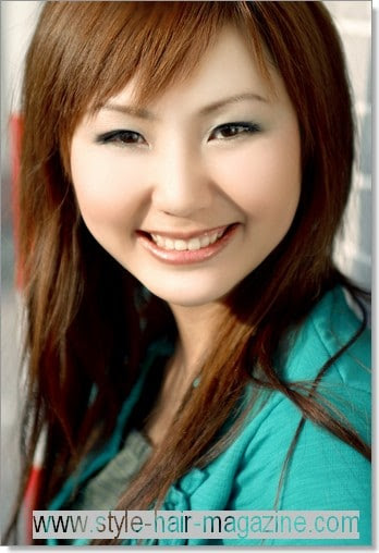 Sleek, long layered hair style with choppy bangs.