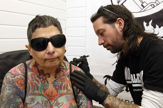 The mother-of-one says her husband, Ron, and tattoo artist Grez Bowman have acted as her eyes, describing details of the intricate artwork from her neck down to her ankles