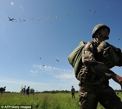 Historic: A French soldier walks in Sainte-Mere-Eglise, northern France, during a D-Day commemoration with paratroopers to mark the 70th anniversary of the World War II Allied landings in Normandy