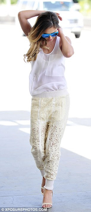 Cool blue: The 32-year-old looked every inch the glamorous superstar as she strutted through the departures terminal with blue shades used to add a pop of colour to her ensemble