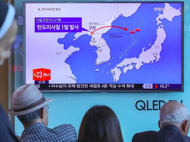 People watch a television news program, showing a graphic of a North Korean missile launch in Seoul yesterday. Picture: Yonhap/AFP