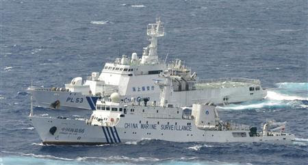 A Chinese marine surveillance cruises next to a Japan Coast Guard patrol ship in the East China Sea, known as the Senkaku isles in Japan and Diaoyu islands in China