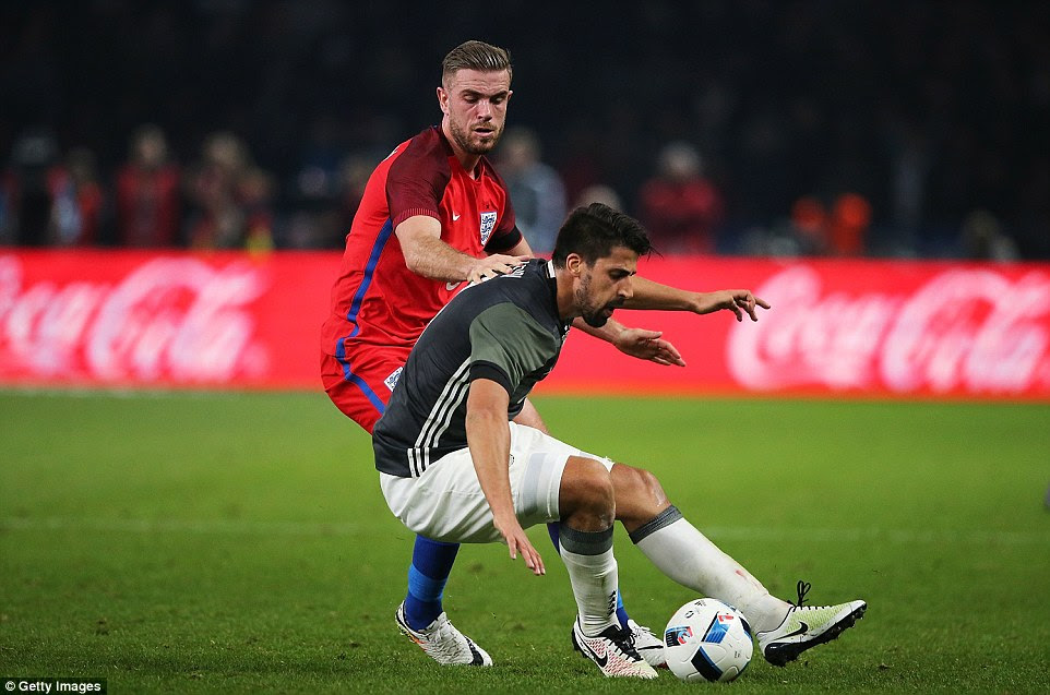 Liverpool's Jordan Henderson keeps a close eye on fellow midfielder Khedira as he aims to win back possession for his side