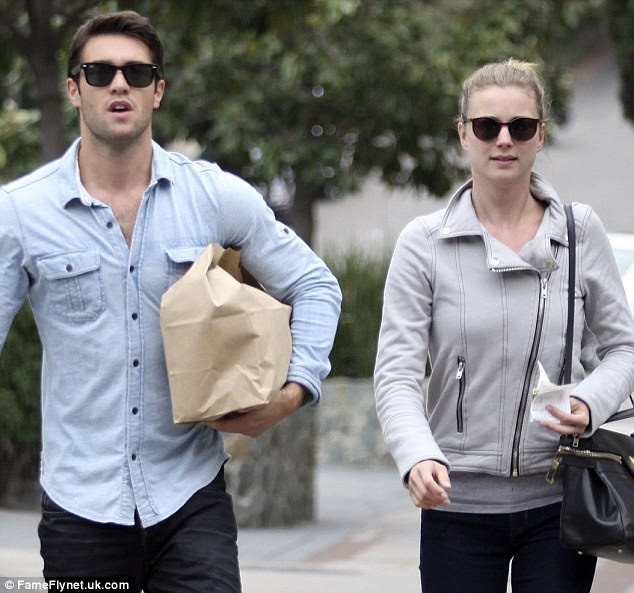 Book keeper: The 26-year-old actress appeared to be in charge of their grocery funds, carrying a receipt and cash in her left hand
