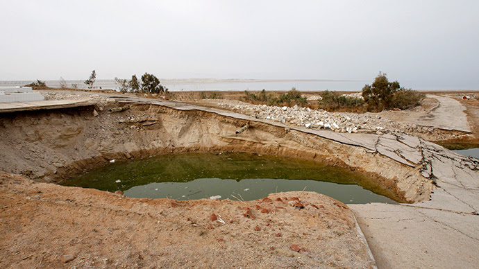 A sinkhole filled with water is seen on the southern shores of the Dead Sea (Reuters)