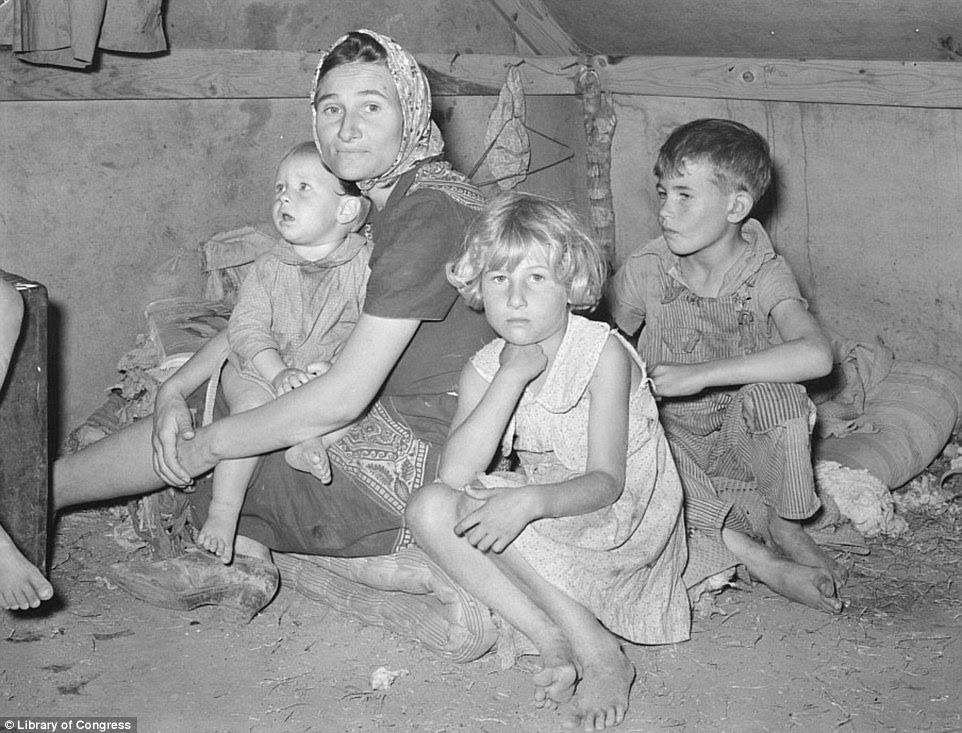 Another family in Weslaco Texas sit barefoot on their humble mattress  on the hay-littered floor in February 1939, offering Lee a rare glimpse into family life during the Great Depression