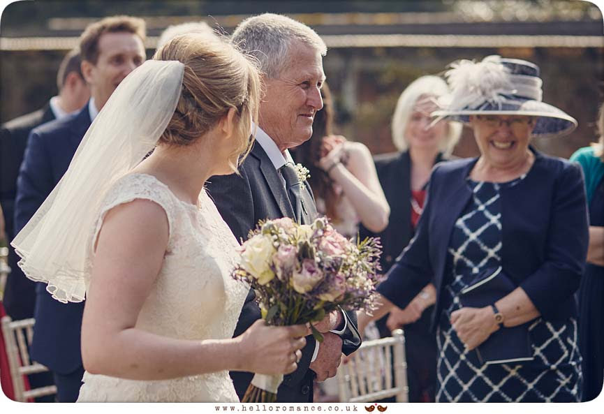 Bride looking at her mother at outdoor wedding ceremony at Woodhall Manor - www.helloromance.co.uk