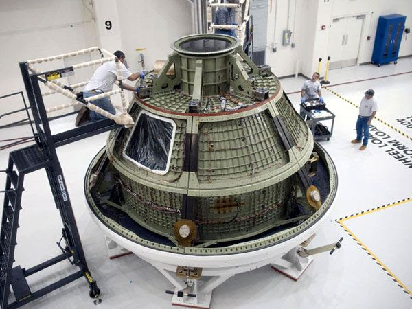 KSC technicians work on the Orion GTA after its arrival inside the O&C Facility on April 21, 2012.