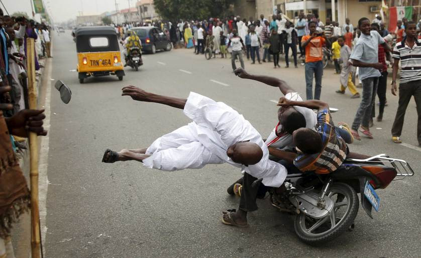 Supporters of the presidential candidate Muhammadu Buhari and his All Progressive Congress hits another supporter with a motorbike during celebrations in Kano